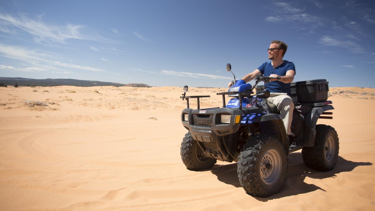 Riding an ATV at Coral Pink Sand Dunes State Park in Kanab, Utah Riding an ATV at Coral Pink Sand Dunes State Park in Kanab, Utah