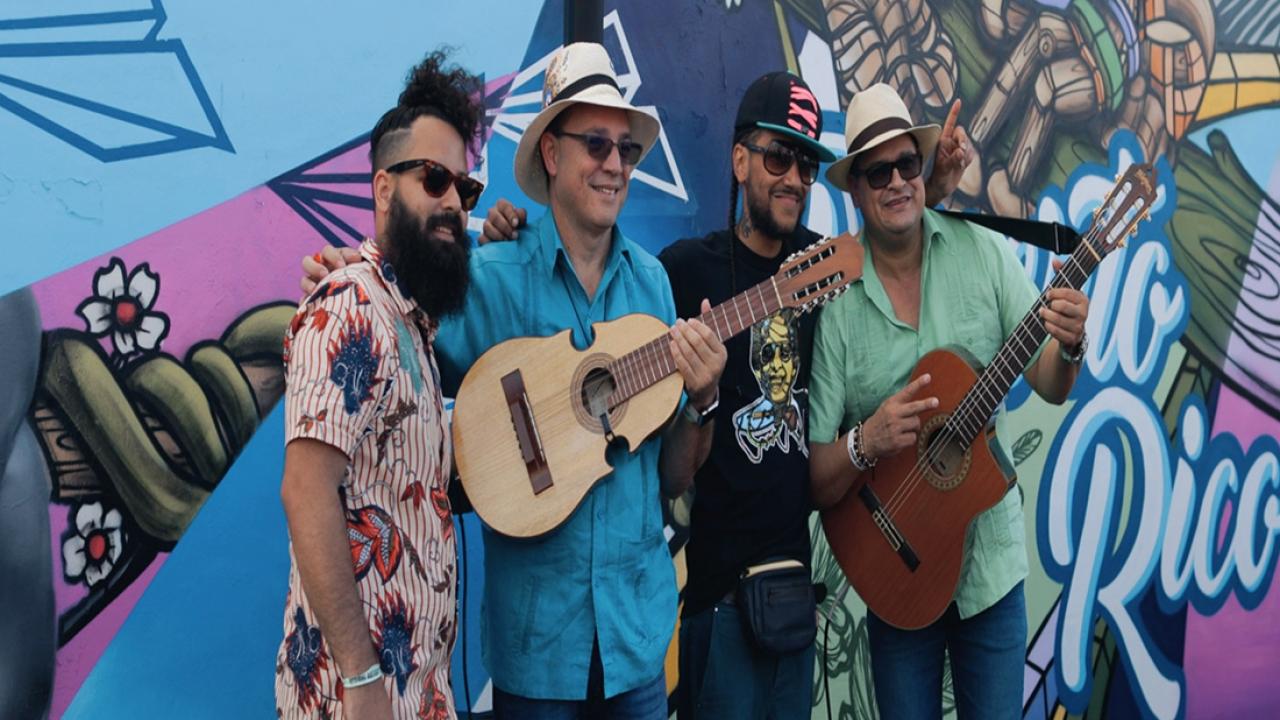 Street artists and musicians posing in front of a Miami, Florida, mural