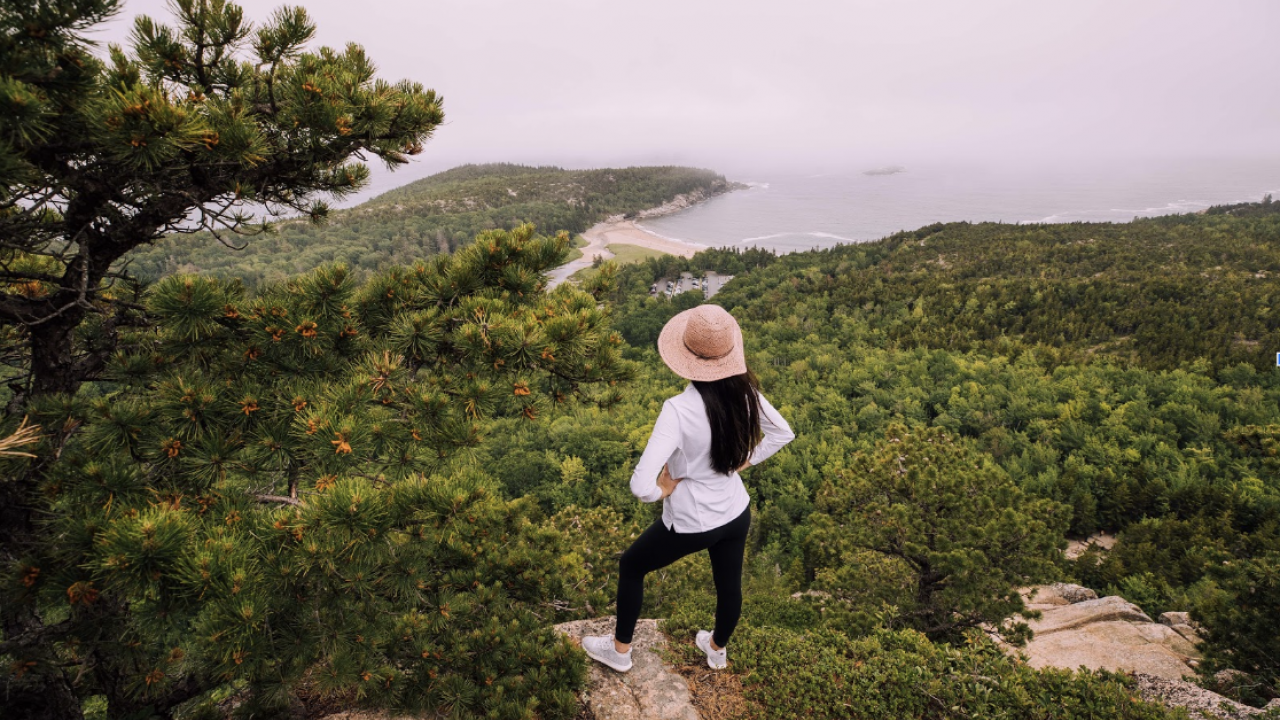 A hiker overlooking the coast of Maine