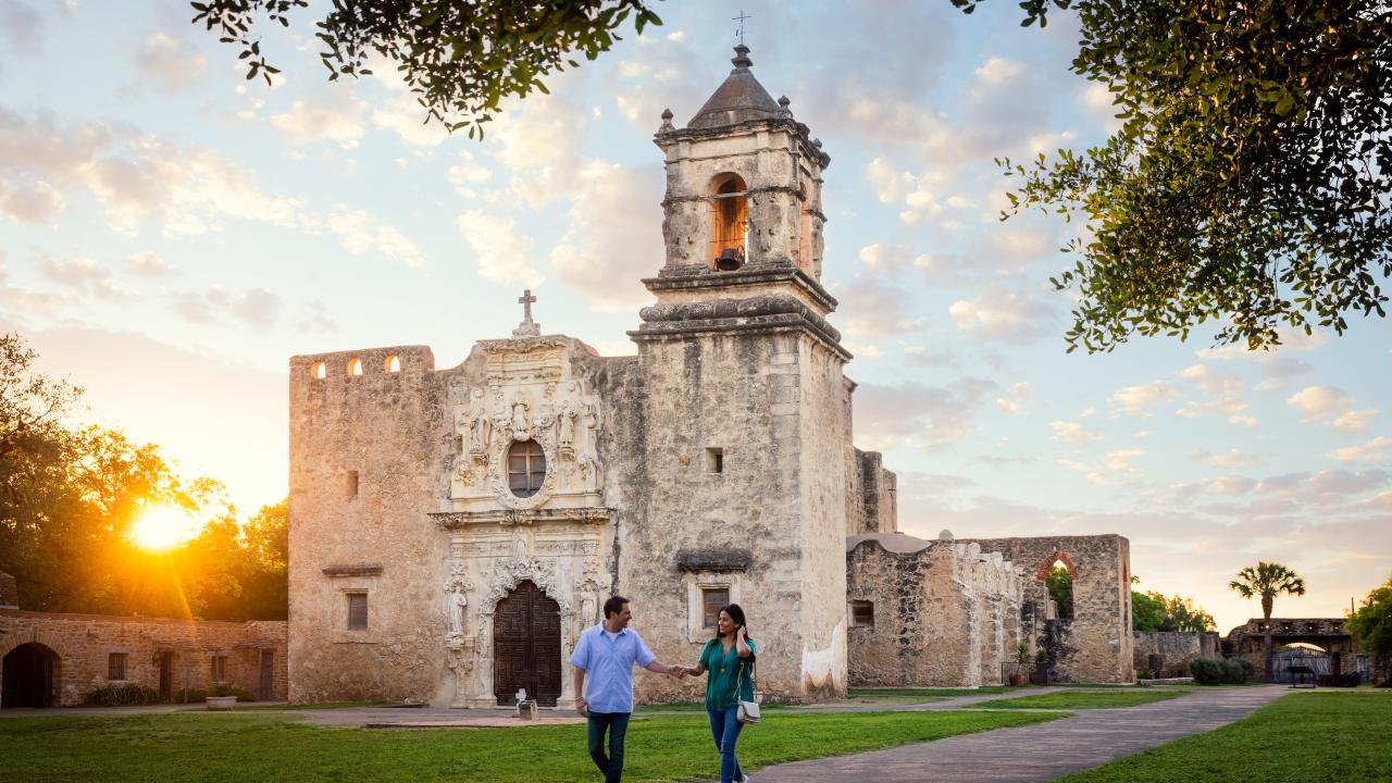 Couple strolling the grounds of Mission San Jose in San Antonio, Texas