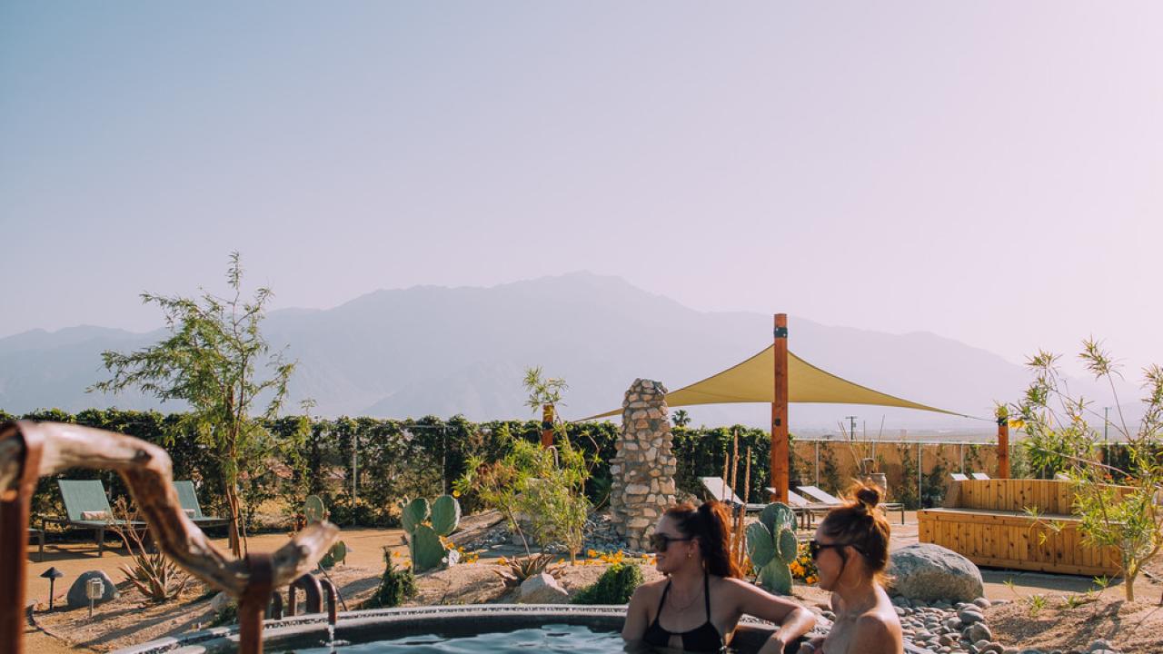 Soaking it a hot tub surrounded by desert landscapes near Palm Springs, California