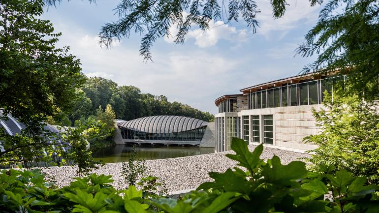 The intriguing exterior of Crystal Bridges Museum of American Art tucked into the surrounding forest The intriguing exterior of Crystal Bridges Museum of American Art tucked into the surrounding forest
