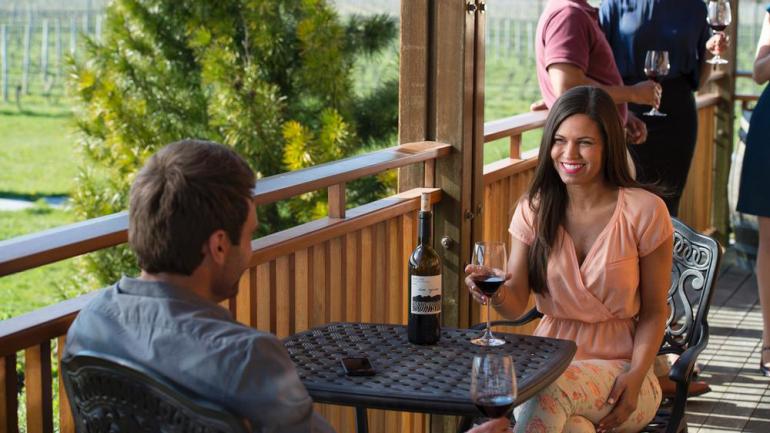 Enjoying a glass of wine while visiting one of New York’s many wine trails Enjoying a glass of wine while visiting one of New York’s many wine trails