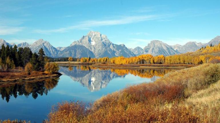 Rugged mountains and a serene valley in Grand Teton National Park Rugged mountains and a serene valley in Grand Teton National Park