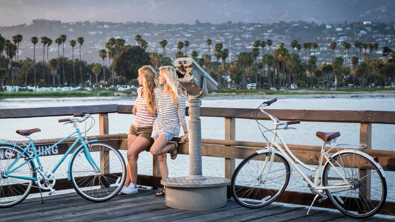 Two women taking a break from riding their bikes in San Diego, California Two women taking a break from riding their bikes in San Diego, California