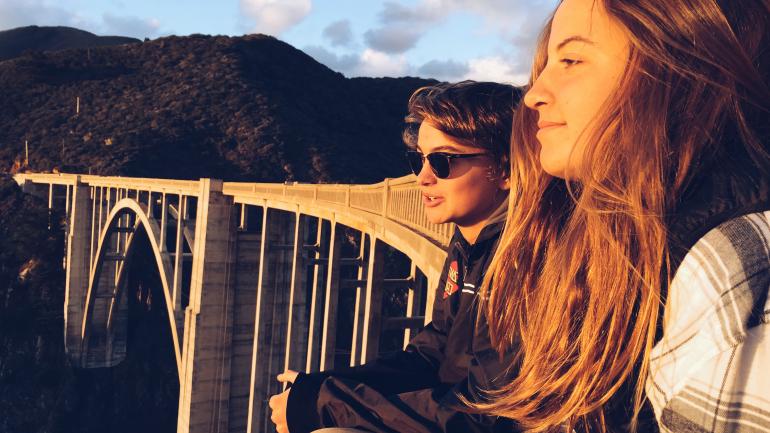 Teenagers admiring the view from Bixby Bridge in Big Sur, California Teenagers admiring the view from Bixby Bridge in Big Sur, California