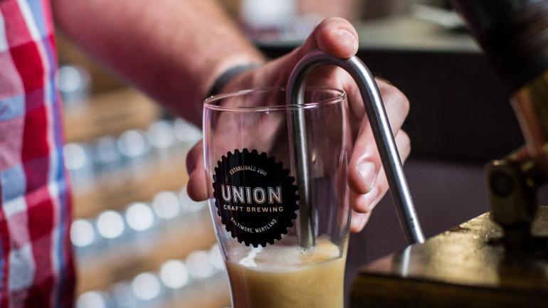 Sip on a cask-poured beer in the taproom at Union Craft Brewing in Baltimore, Maryland. Sip on a cask-poured beer in the taproom at Union Craft Brewing in Baltimore, Maryland.