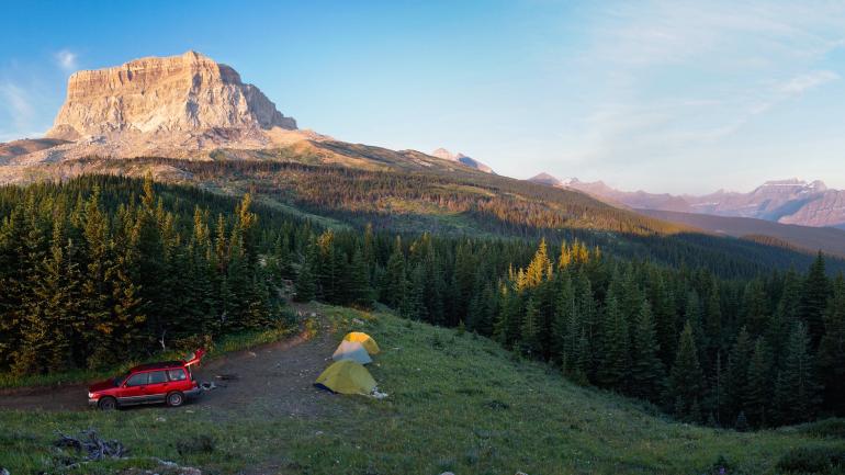 Campers set up their tents with an impressive view in the Blackfeet Indian Reservation. Campers set up their tents with an impressive view in the Blackfeet Indian Reservation.