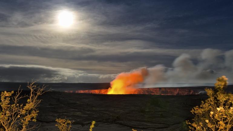 Plumes of smoke and ash rise from a volcanic crater at Hawaiʻi Volcanoes National Park Plumes of smoke and ash rise from a volcanic crater at Hawaiʻi Volcanoes National Park