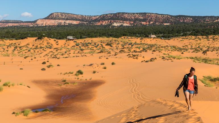 Walking through Coral Pink Sand Dunes State Park in Utah Walking through Coral Pink Sand Dunes State Park in Utah