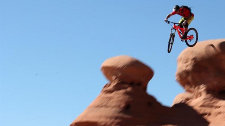 Professional mountain biker Eric Porter leaping from a cliff near Moab, Utah Professional mountain biker Eric Porter leaping from a cliff near Moab, Utah