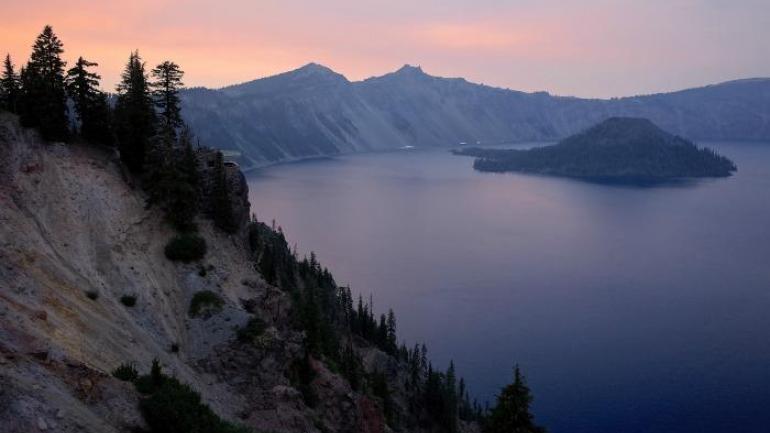We spent one glorious evening watching the red sun slowly set over Crater Lake, hazy and mysterious. We spent one glorious evening watching the red sun slowly set over Crater Lake, hazy and mysterious.