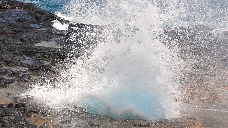 The famed water display through the lava rock of Puhi, or Spouting Horn The famed water display through the lava rock of Puhi, or Spouting Horn