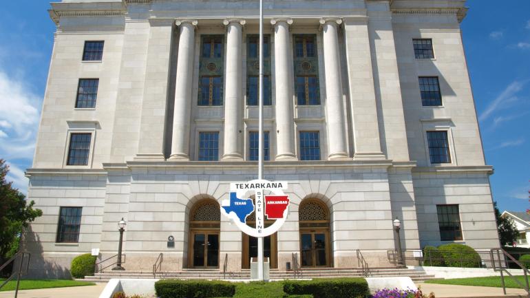 The Texas-Arkansas stateline outside the Texarkana post office, which sits in two states The Texas-Arkansas stateline outside the Texarkana post office, which sits in two states