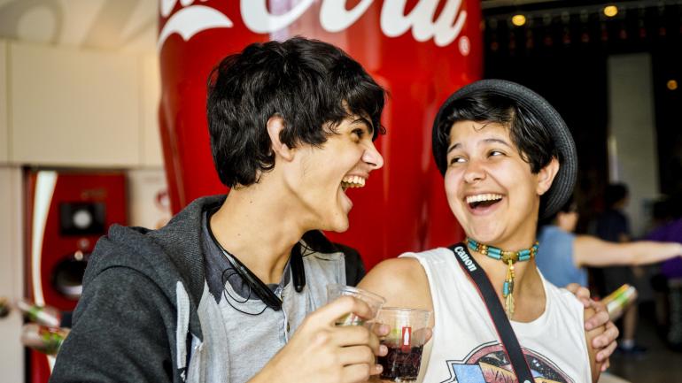 Friends enjoying the Taste It! Exhibit, where you can sample Coca-Cola products from around the world Friends enjoying the Taste It! Exhibit, where you can sample Coca-Cola products from around the world