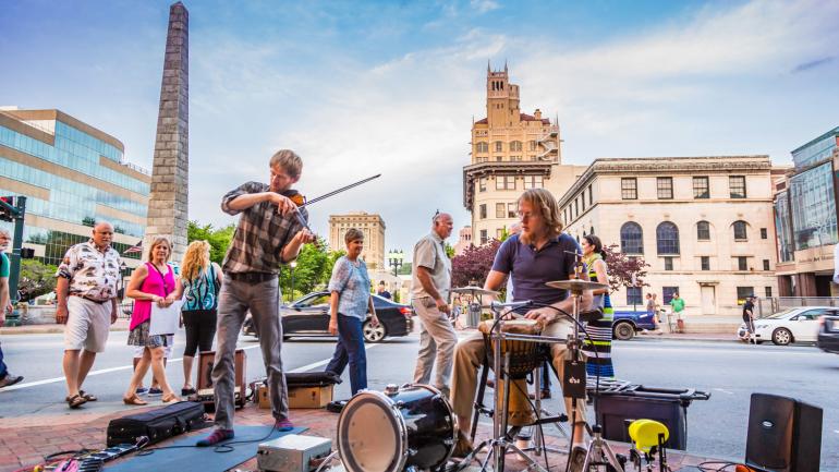 Performers play live music on the streets of Asheville, North Carolina Performers play live music on the streets of Asheville, North Carolina