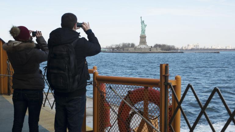 Snapping photos of the iconic Statue of Liberty from the Staten Island Ferry Snapping photos of the iconic Statue of Liberty from the Staten Island Ferry