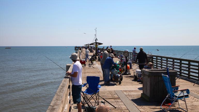Casting lines off the popular fishing spot, the Jacksonville Pier Casting lines off the popular fishing spot, the Jacksonville Pier