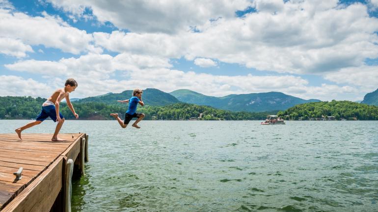 Children leap off a dock at Lake Lure Children leap off a dock at Lake Lure