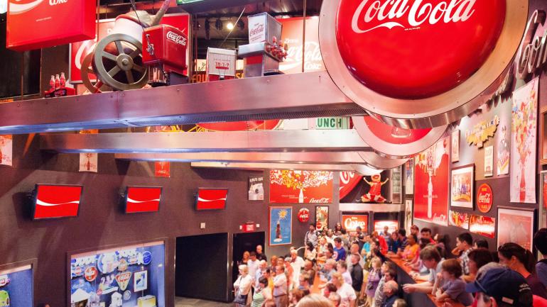 Visitors learning more about Coca-Cola history in the Loft exhibit at World of Coca-Cola Visitors learning more about Coca-Cola history in the Loft exhibit at World of Coca-Cola