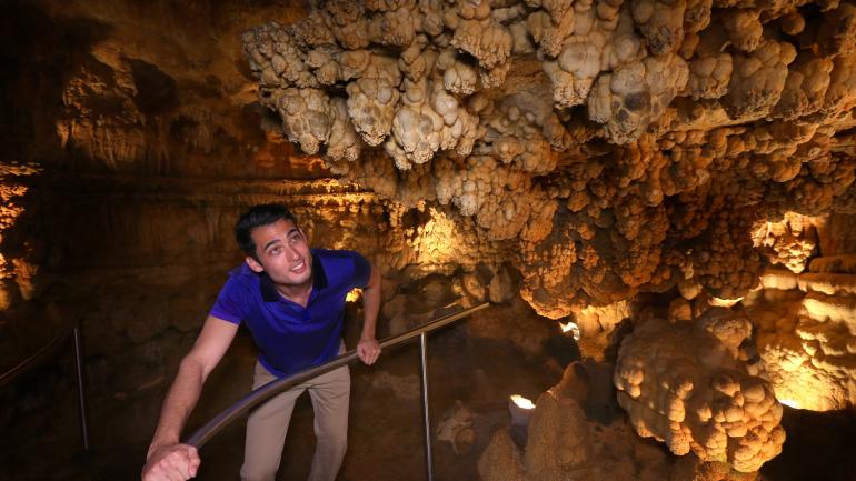 Navigating the underground tunnels at Meramec Caverns in Missouri Navigating the underground tunnels at Meramec Caverns in Missouri