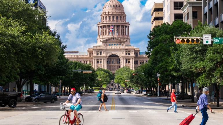 Pedestrians in motion outside of the state capitol in Austin, Texas Pedestrians in motion outside of the state capitol in Austin, Texas