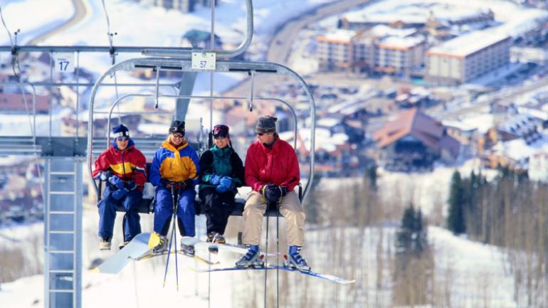 Family time riding a Crested Butte ski lift in Colorado Family time riding a Crested Butte ski lift in Colorado