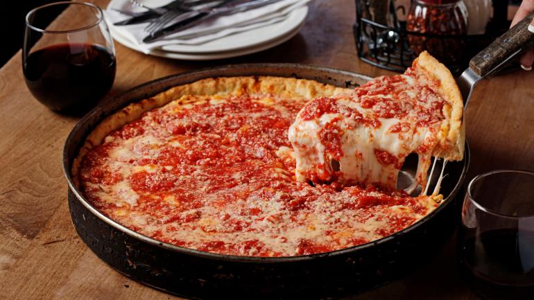 A Chicago-style deep-dish pizza, a deep-molded crust layered with cheese, toppings and sauce A Chicago-style deep-dish pizza, a deep-molded crust layered with cheese, toppings and sauce