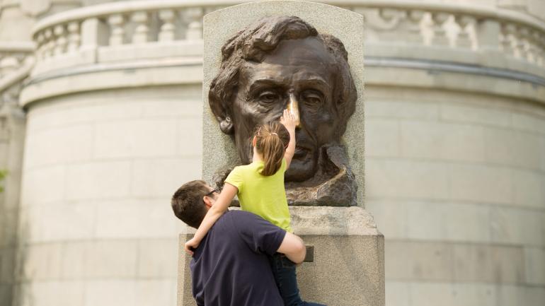 Rubbing the nose of the Abraham Lincoln bust for good luck at his tomb in Springfield, Illinois Rubbing the nose of the Abraham Lincoln bust for good luck at his tomb in Springfield, Illinois