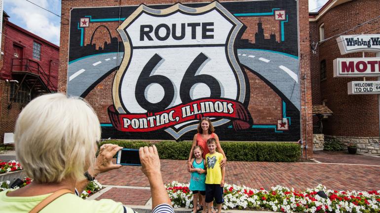 Posing in front of the classic Route 66 mural in Pontiac, Illinois Posing in front of the classic Route 66 mural in Pontiac, Illinois