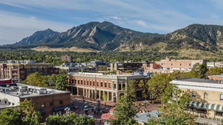 A view of the downtown Pearl Street Mall district and the Rocky Mountains in Boulder A view of the downtown Pearl Street Mall district and the Rocky Mountains in Boulder