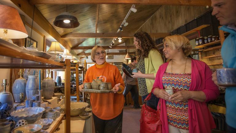 Visitors shop for artisanal pottery at Tater Knob Pottery & Farm near Berea, Kentucky Visitors shop for artisanal pottery at Tater Knob Pottery & Farm near Berea, Kentucky