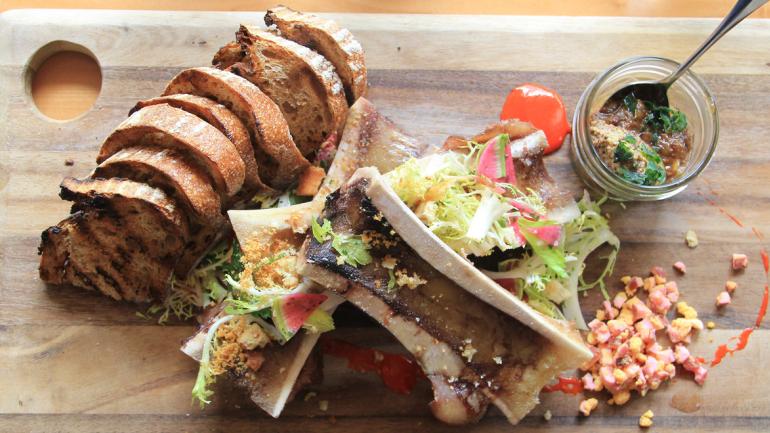 Chargrilled-bread accompanies a bone marrow appetizer Chargrilled-bread accompanies a bone marrow appetizer