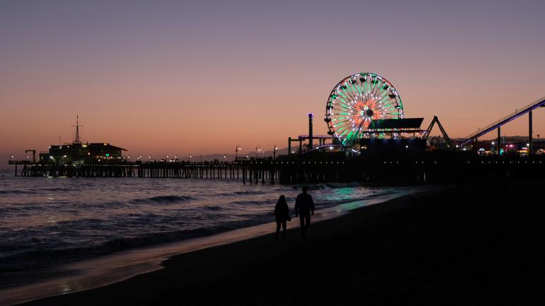The sun sets over the pier outside Los Angeles, California. The sun sets over the pier outside Los Angeles, California.