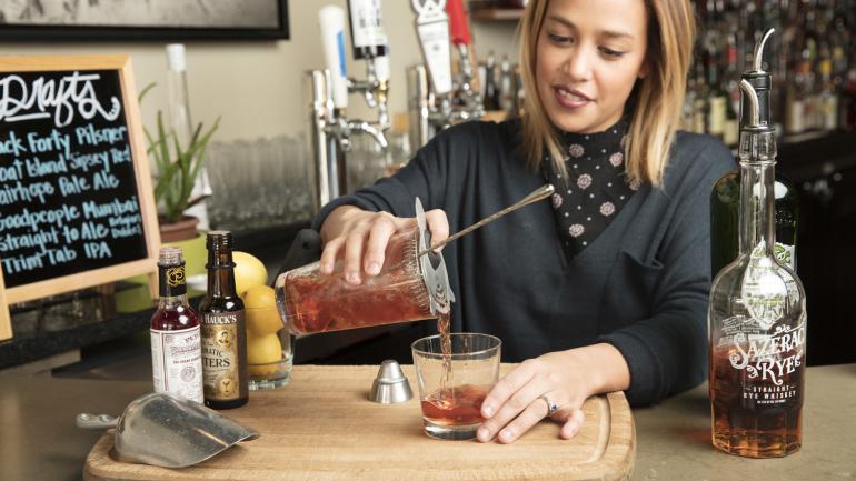 Bartender mixing up a craft cocktail Bartender mixing up a craft cocktail