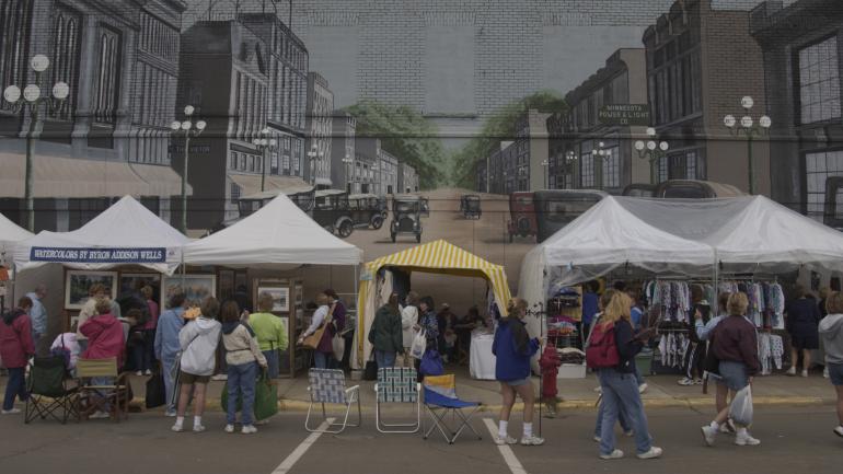 Browsing the Little Falls Arts & Crafts Festival among the town's famed mural art Browsing the Little Falls Arts & Crafts Festival among the town's famed mural art