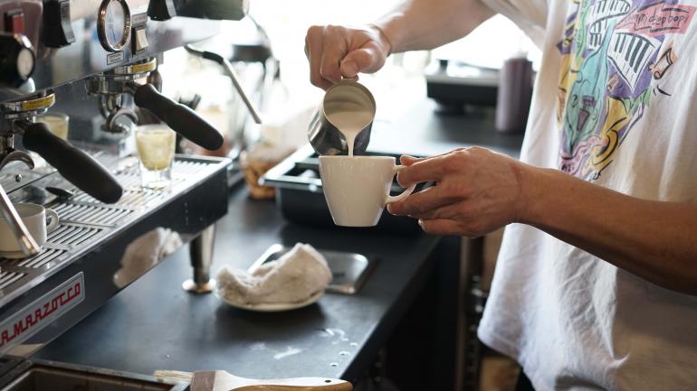 A barista preparing a beverage at a local Portland coffee shop A barista preparing a beverage at a local Portland coffee shop