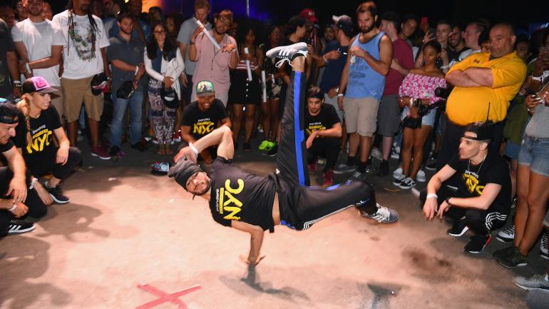 Taking a turn to perform impressive breakdancing moves Taking a turn to perform impressive breakdancing moves