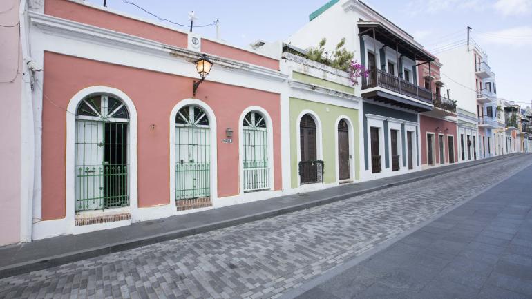 Colorful buildings line a cobblestone street in Old San Juan Colorful buildings line a cobblestone street in Old San Juan