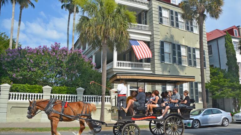 A Charleston carriage riding along historic Battery Street, where you'll see 18th-century Georgian townhomes A Charleston carriage riding along historic Battery Street, where you'll see 18th-century Georgian townhomes