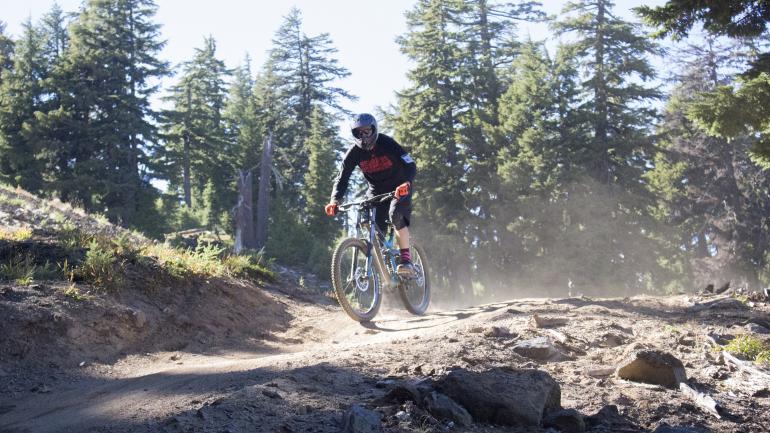 Mountain biker gripping for a downhill run Mountain biker gripping for a downhill run