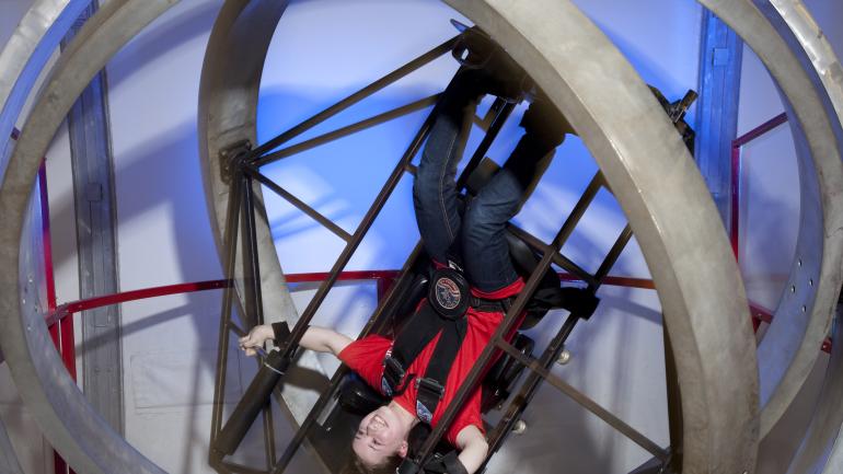 Riding the Multi Axis training simulator, which creates the sensation of what it’s like to tumble through space Riding the Multi Axis training simulator, which creates the sensation of what it’s like to tumble through space