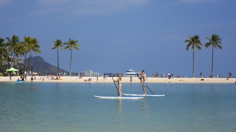 Stand-up paddleboarding in the lagoon at Hilton Hawaiian Village Waikiki Beach Resort in Honolulu Stand-up paddleboarding in the lagoon at Hilton Hawaiian Village Waikiki Beach Resort in Honolulu