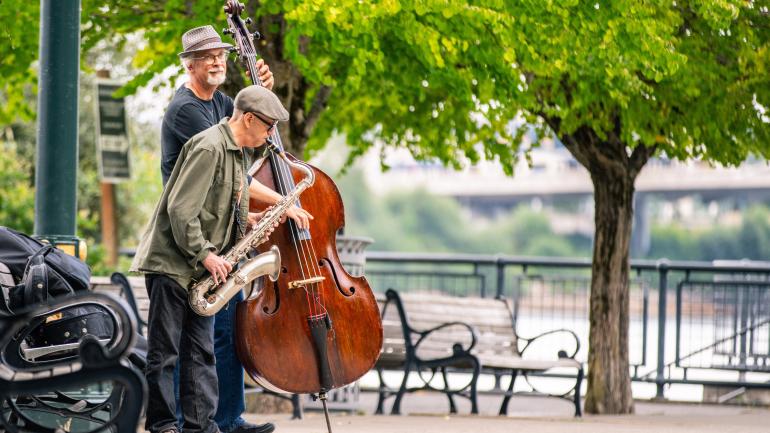Street musicians performing along the riverfront in Portland Street musicians performing along the riverfront in Portland