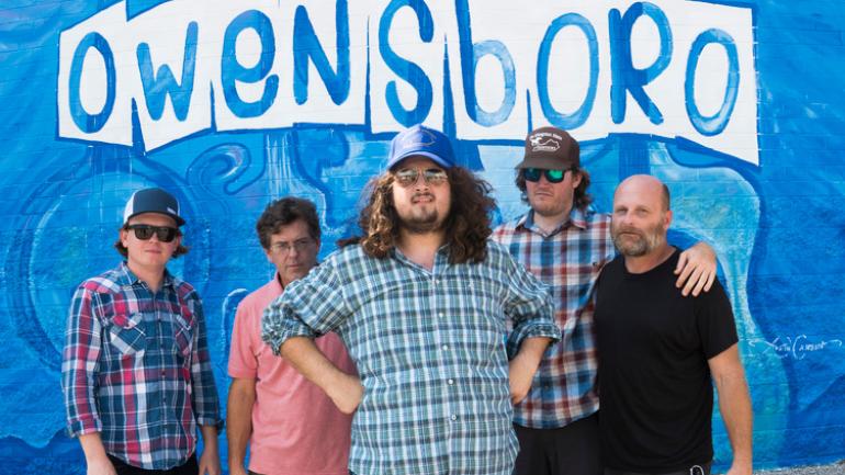 The Wooks posing with a mural in Owensboro The Wooks posing with a mural in Owensboro