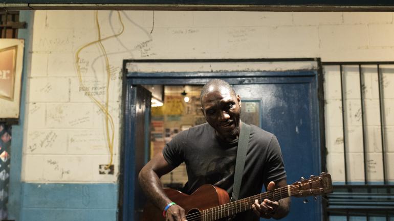 Cedric Burnside playing outside the Blue Front Cafe, a juke joint near Jackson Cedric Burnside playing outside the Blue Front Cafe, a juke joint near Jackson