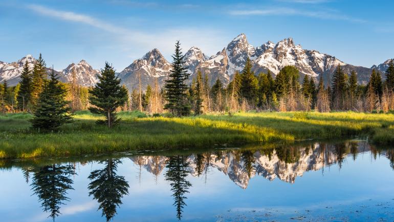 The majestic mountains reflecting in a waterway at Grand Teton National Park, Wyoming The majestic mountains reflecting in a waterway at Grand Teton National Park, Wyoming