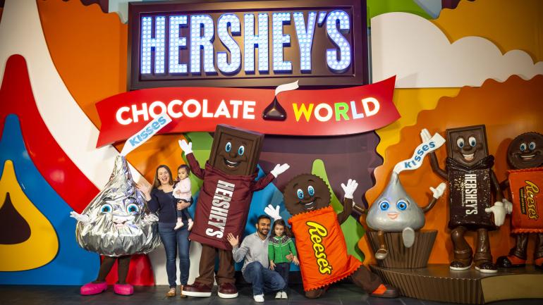 Posing with some of the world’s favorite chocolate candies at Hershey’s Chocolate World in Pennsylvania Posing with some of the world’s favorite chocolate candies at Hershey’s Chocolate World in Pennsylvania