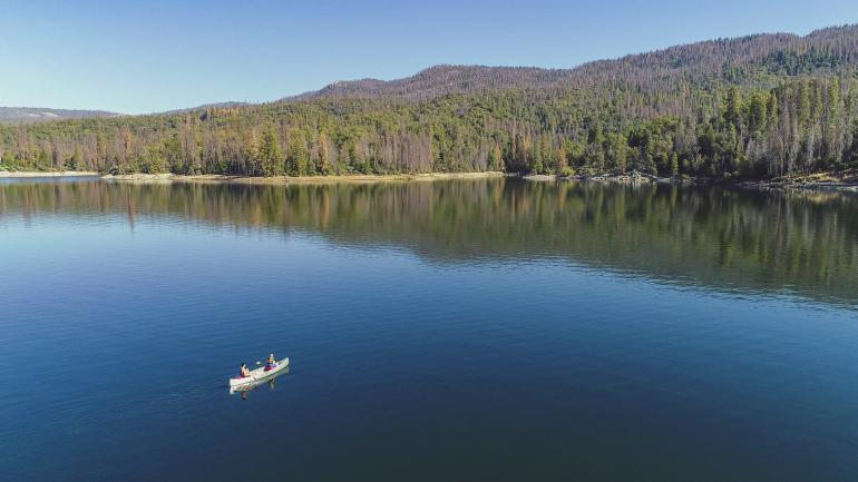 Canoeing on Bass Lake in the Sierra National Forest in Madera County, California Canoeing on Bass Lake in the Sierra National Forest in Madera County, California
