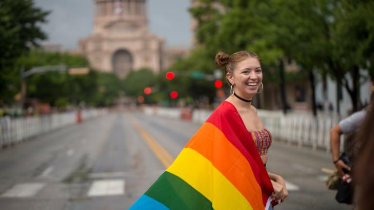 Girl with pride flag near Texas capitol building Girl with pride flag near Texas capitol building